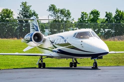 A Learjet 45XR, registration N156DH, parked on the tarmac.