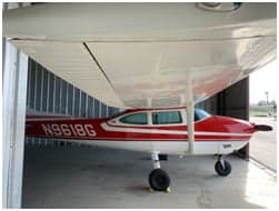 Cessna 182 Skylane N9618G in a hangar with red and white paint scheme.
