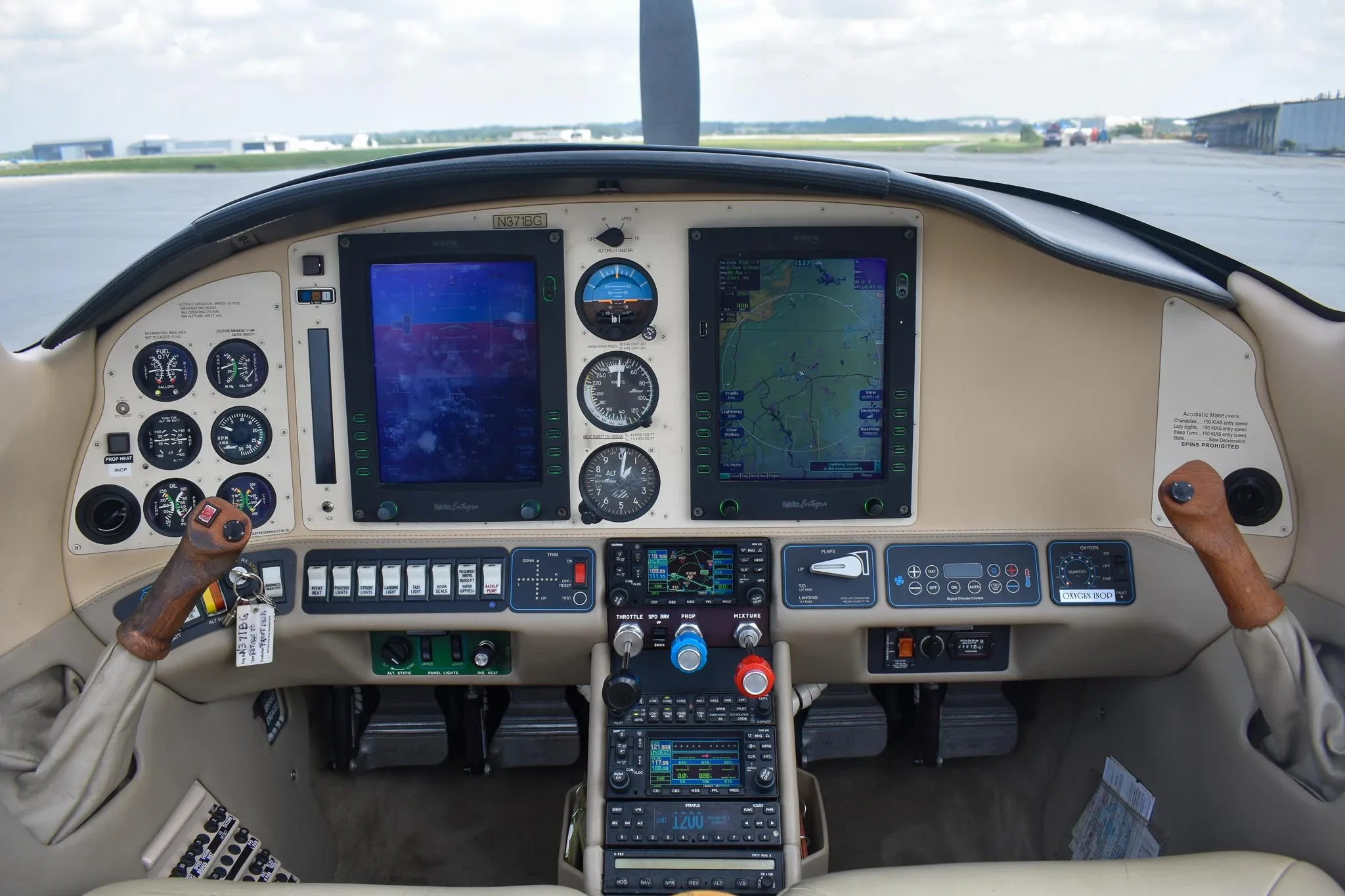 The cockpit of the Columbia 400 aircraft, featuring a glass panel display with dual screens and traditional gauges.