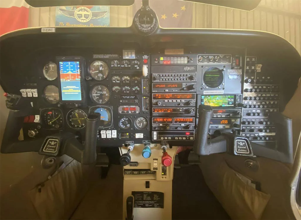 The full instrument panel of an aircraft cockpit, featuring various gauges, screens, and controls.