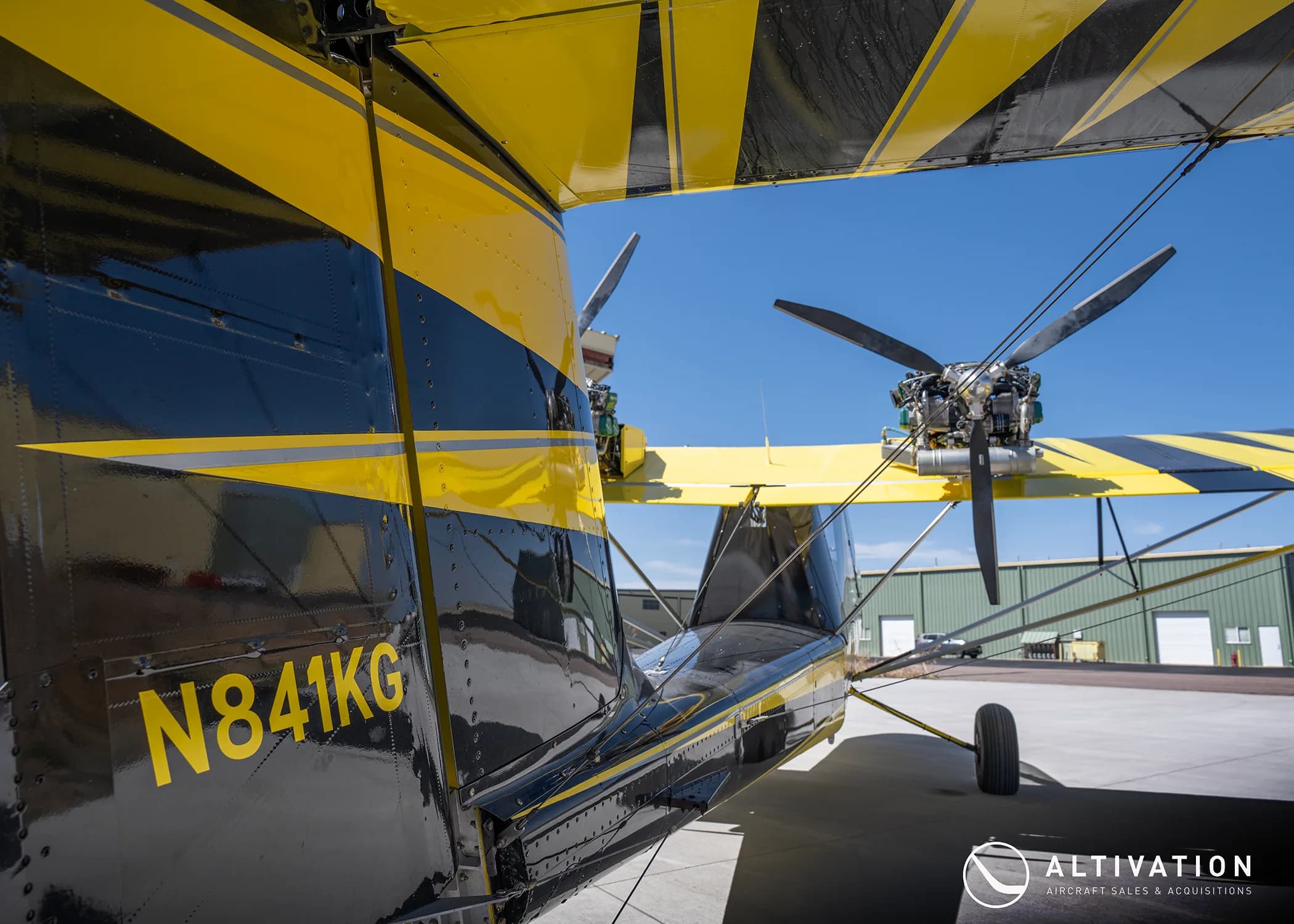 Tail section of a yellow and black AirCam with registration N841KG.