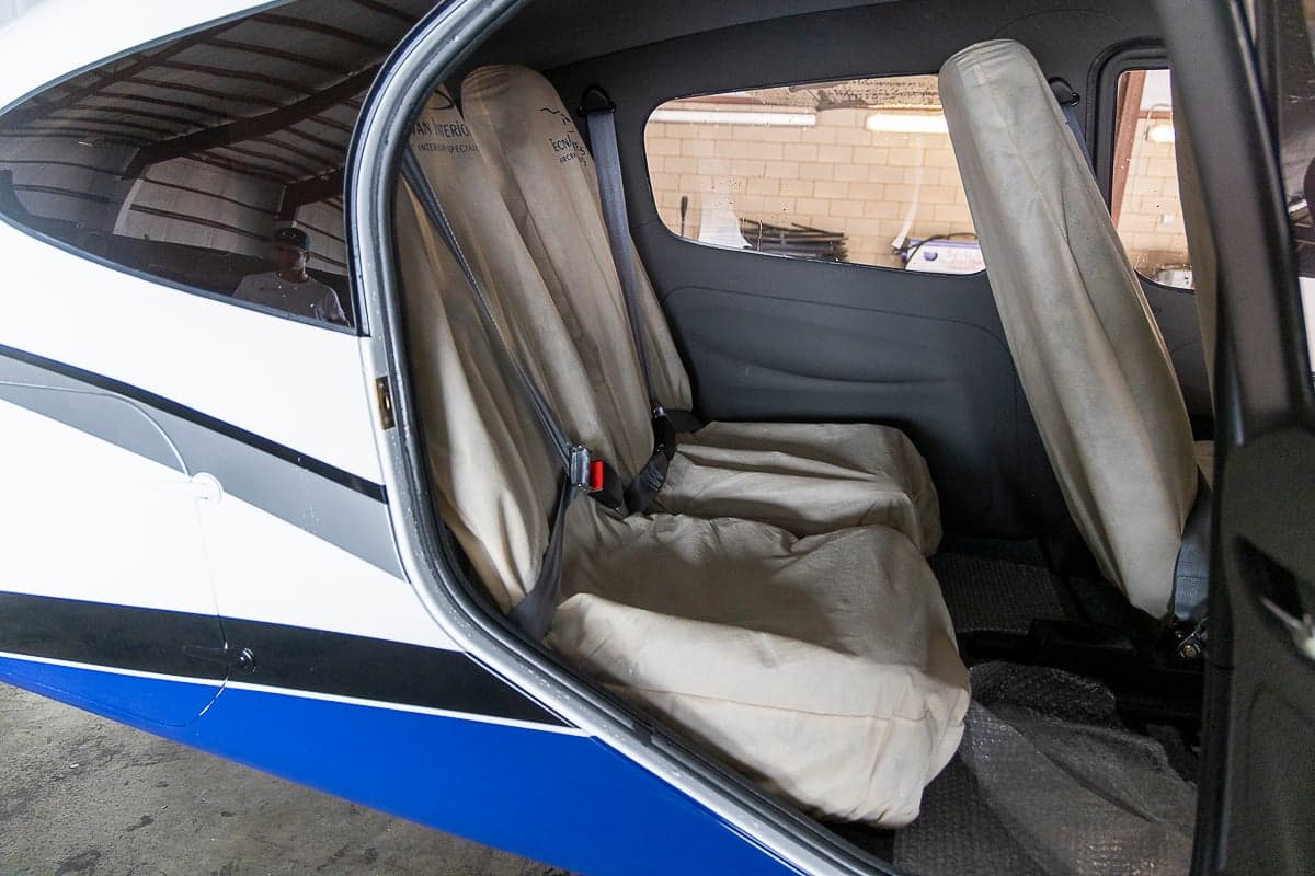 Rear seats of the aircraft with seat covers.