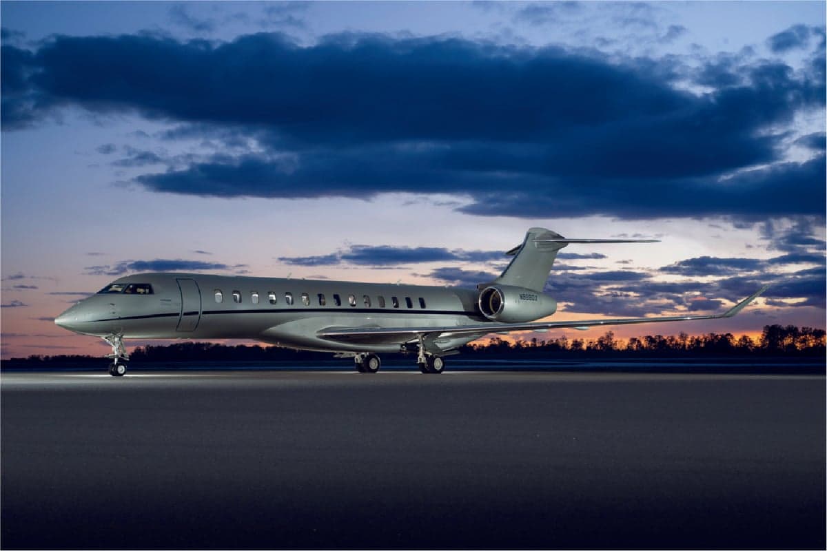 N988DX Bombardier aircraft on the tarmac at dusk.
