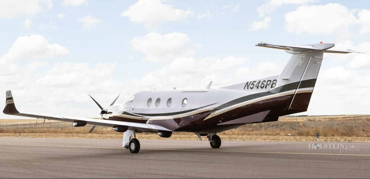 Pilatus PC-12 aircraft N546PB on the runway, rear quarter view.