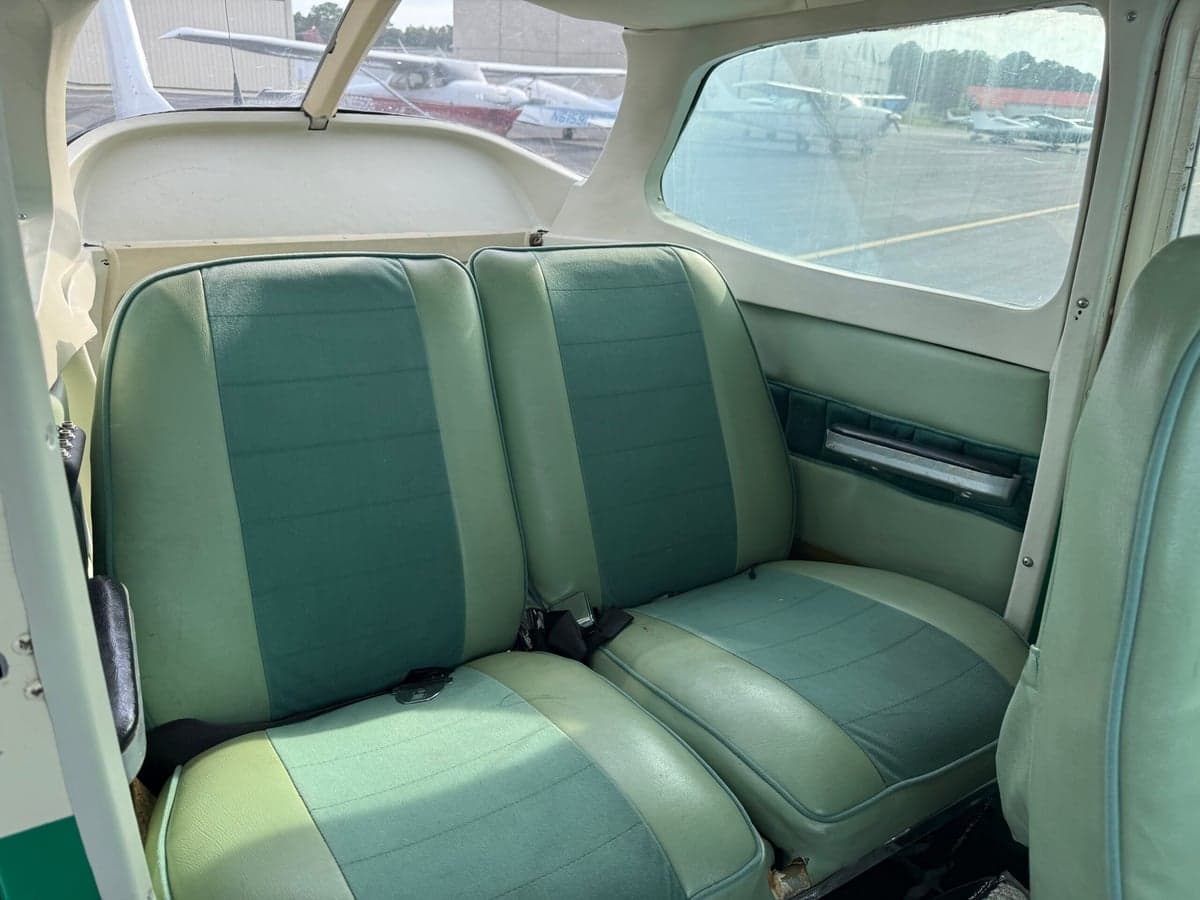 Rear seats of the Cessna 172 Skyhawk with green upholstery.