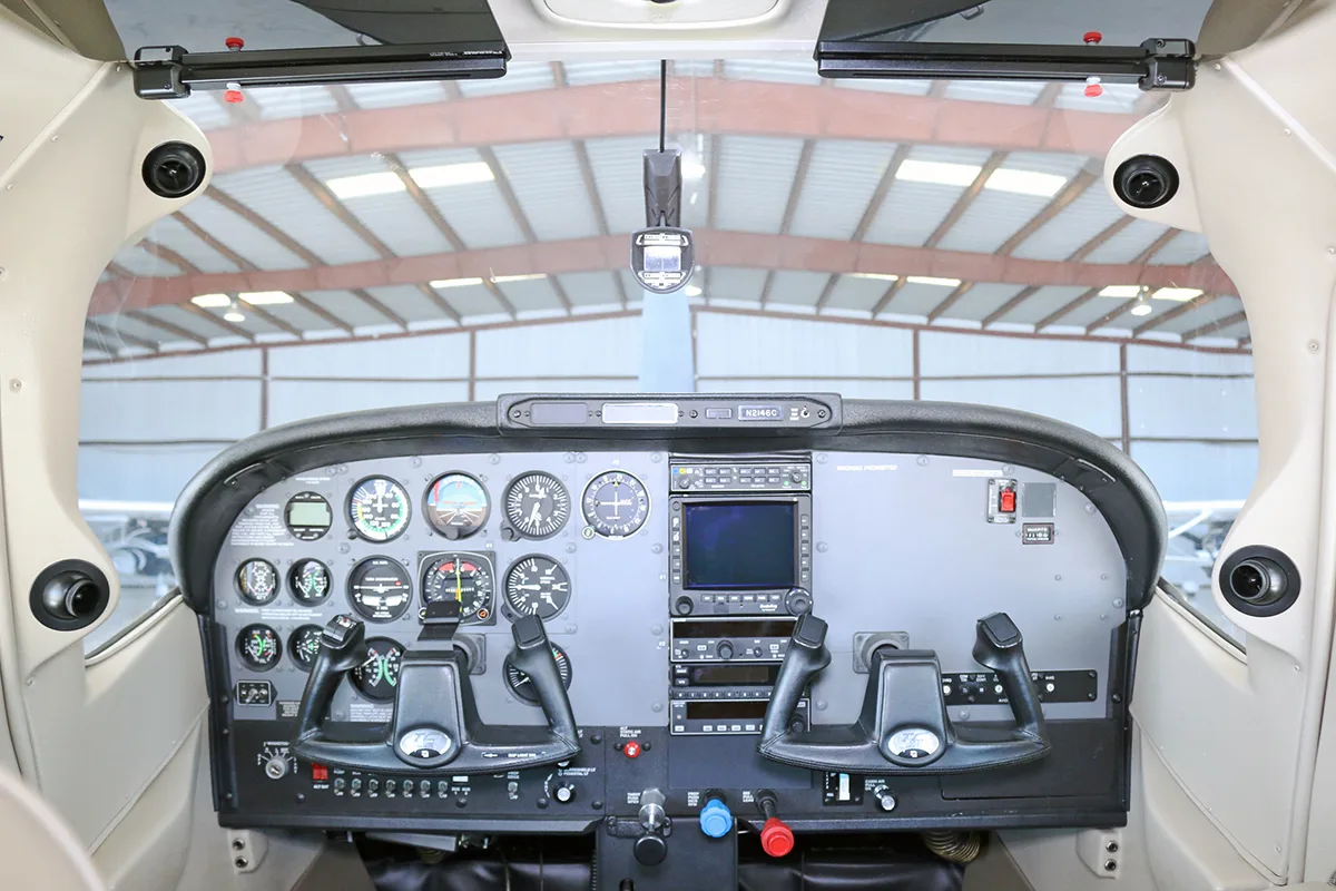 The cockpit instrument panel of the aircraft, featuring analog gauges and a digital display.