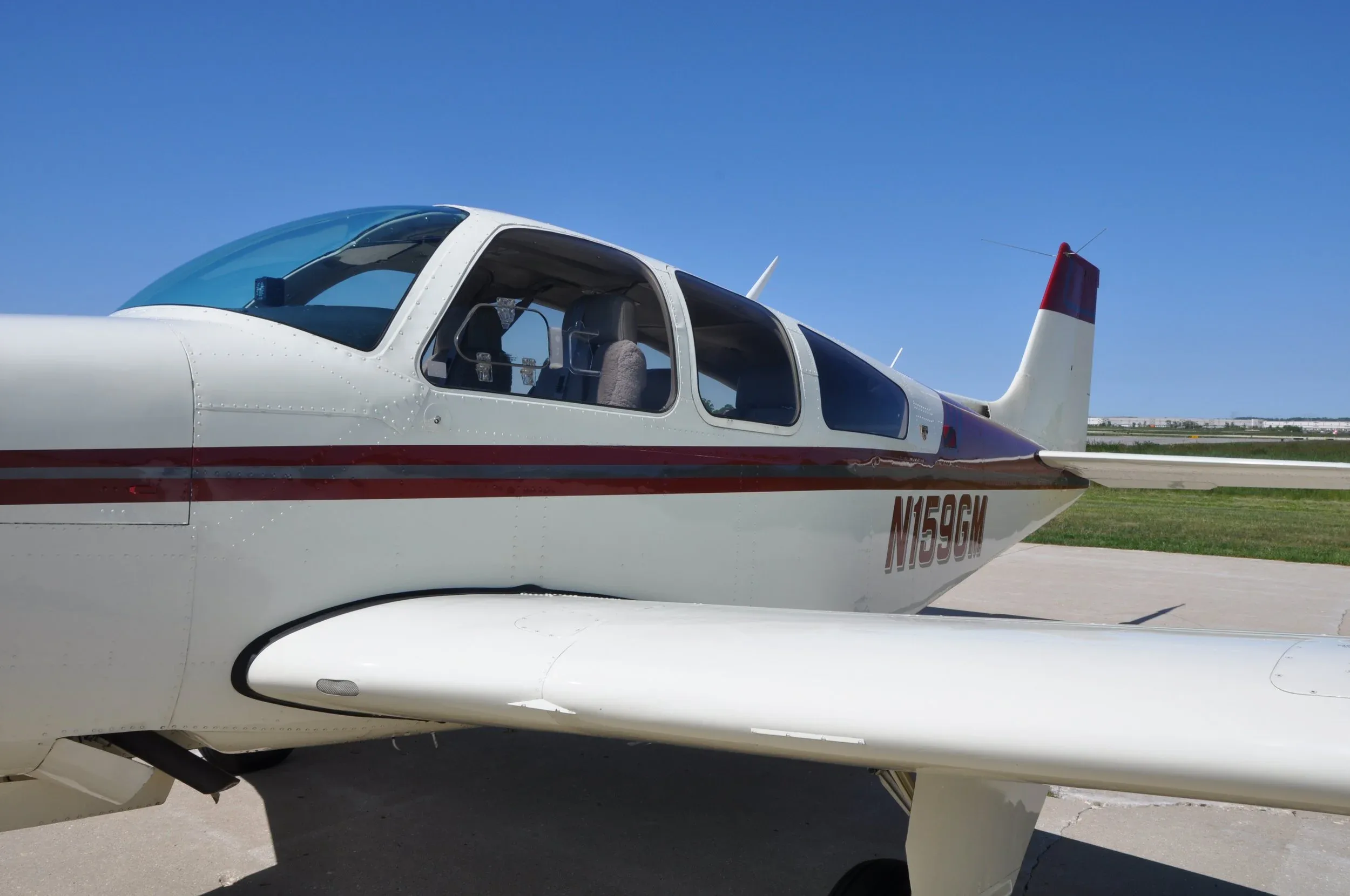 A close-up side view of the aircraft's fuselage with registration N159GM and part of the wing.