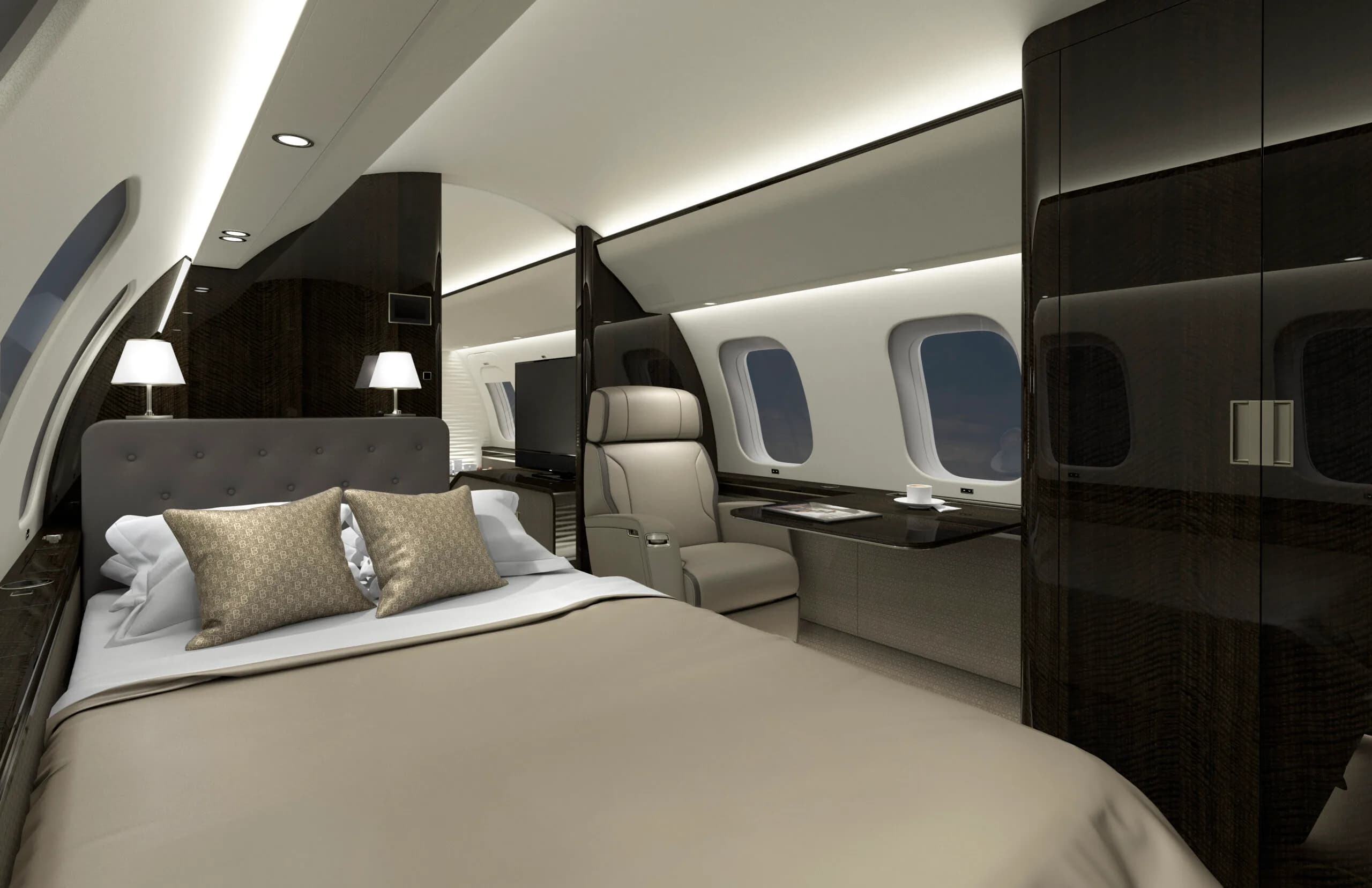 Luxurious aircraft interior with a bed and seating area.