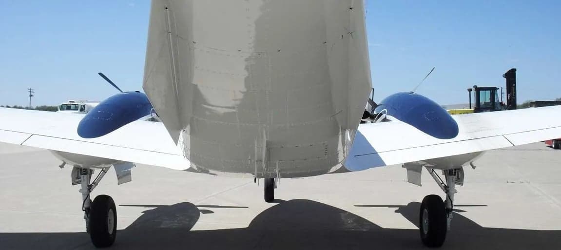 Rear view of the Beechcraft King Air C90B aircraft showing the tail and landing gear.