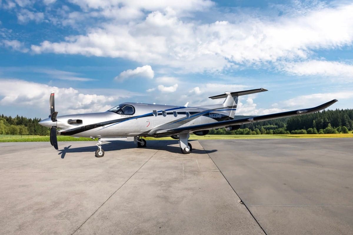 Pilatus PC-12NG with a silver and black paint scheme on the tarmac.