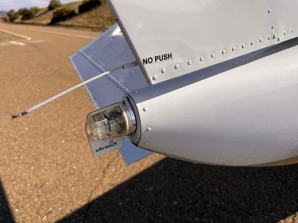 Close-up of the tail light and uAvionix tailBeaconX of the Cessna 210 aircraft N9451X.