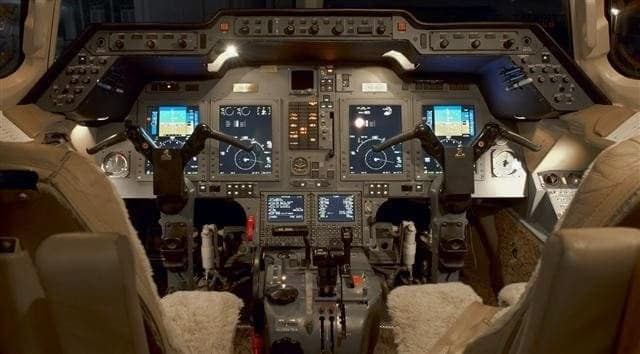 View of the aircraft's cockpit with instrument panel and seats.