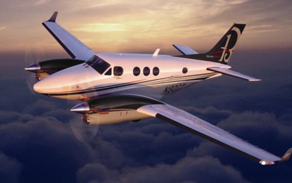 A Beechcraft King Air 350 flying above the clouds.