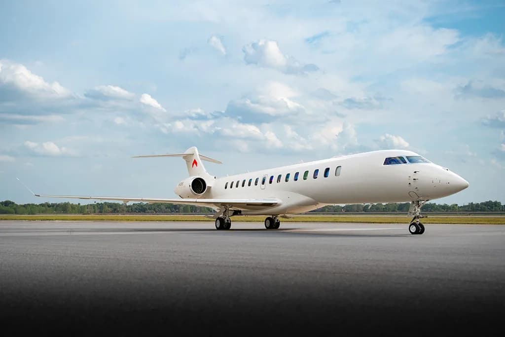 A white Bombardier Global 7500 business jet, tail number N40NS, parked on a tarmac.