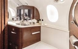Interior of the Falcon jet with a lavatory area.