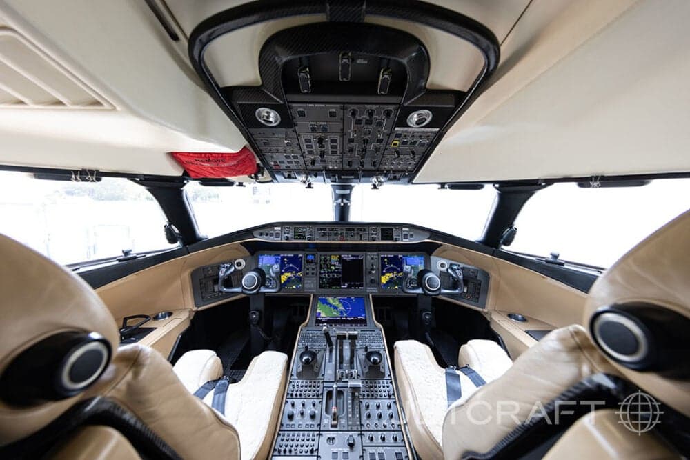 View of the cockpit of a Bombardier Global Express with tan leather seats and modern avionics.