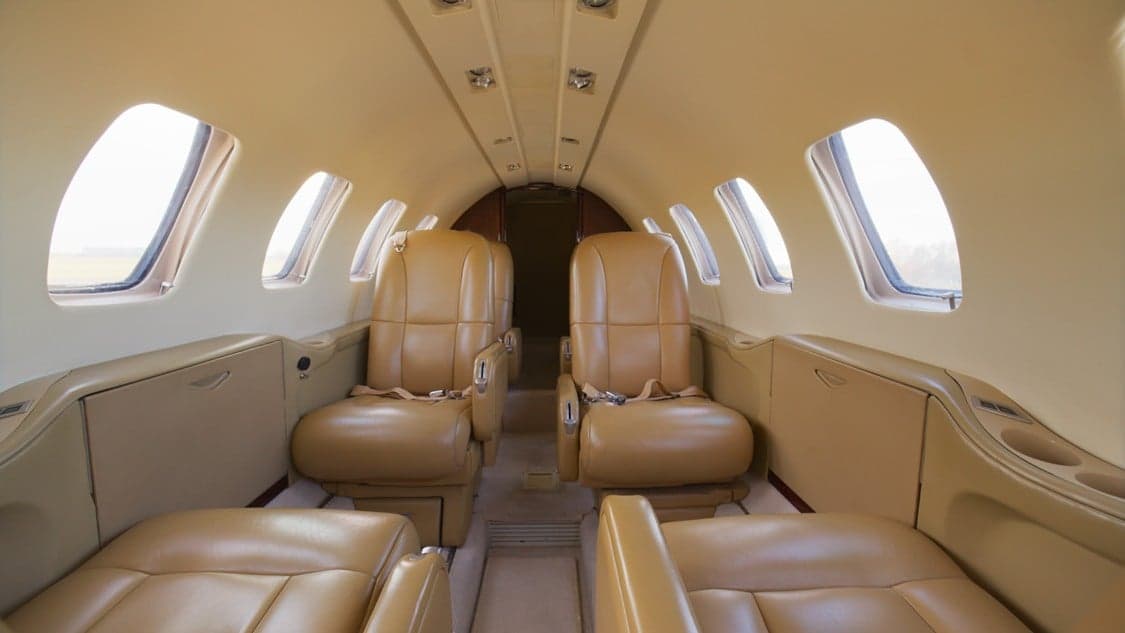 View of the interior cabin with tan leather seats.