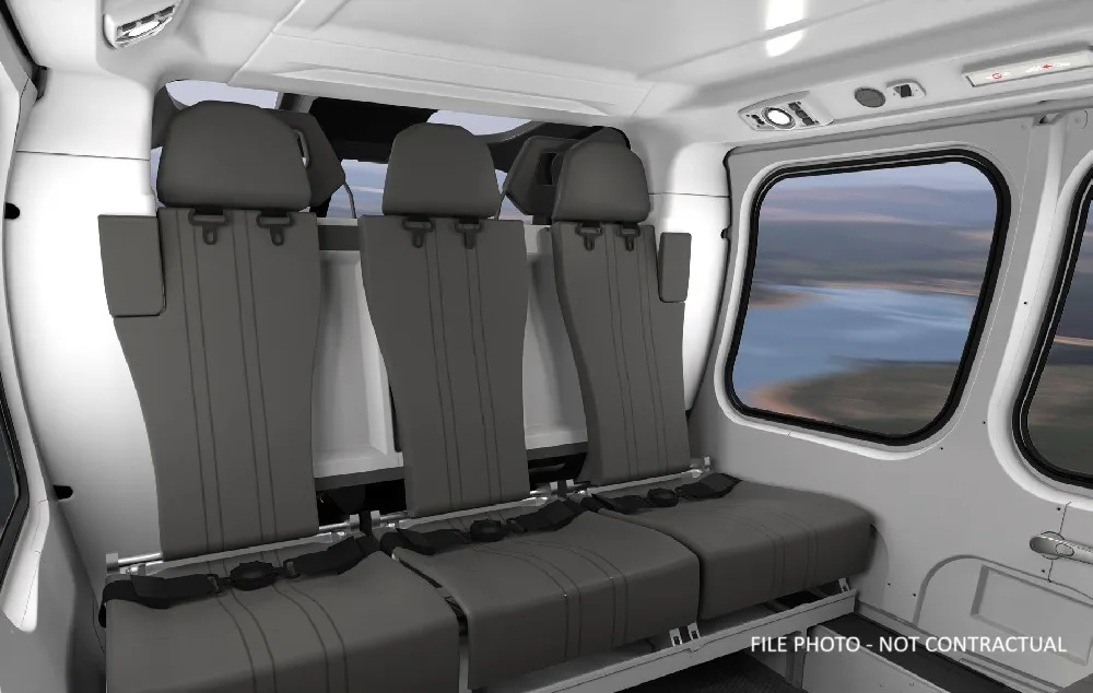 Interior view of the helicopter cabin with grey seats.