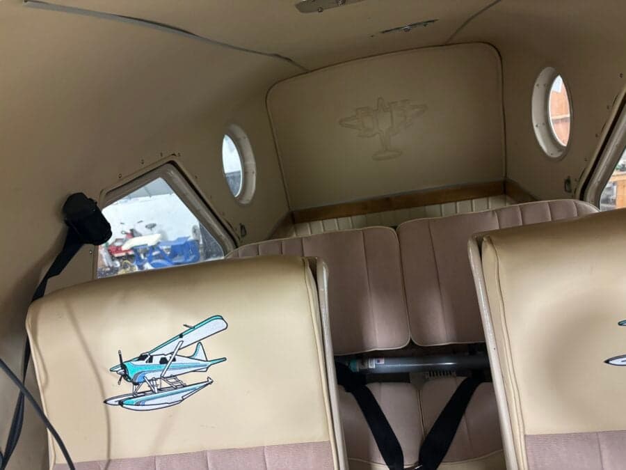 View of the rear of the cabin, showing the seats and a logo on the back wall.