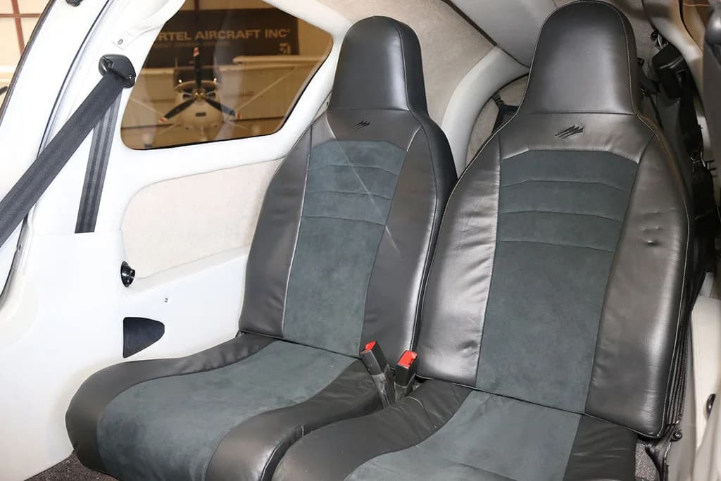 Interior view of two black and grey aircraft seats in the cabin of a Cessna TTX.