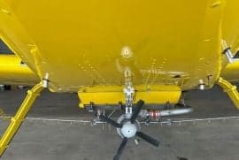 View of the belly of a yellow Air Tractor aircraft.