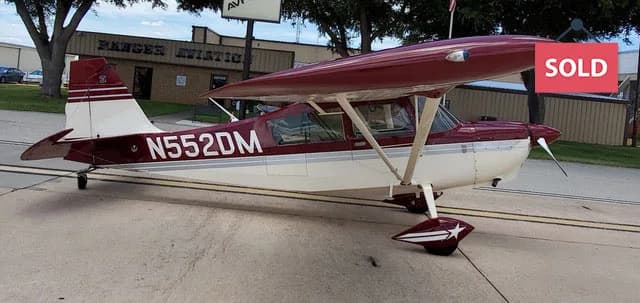 Side view of a light aircraft with the registration number N552DM on the fuselage.