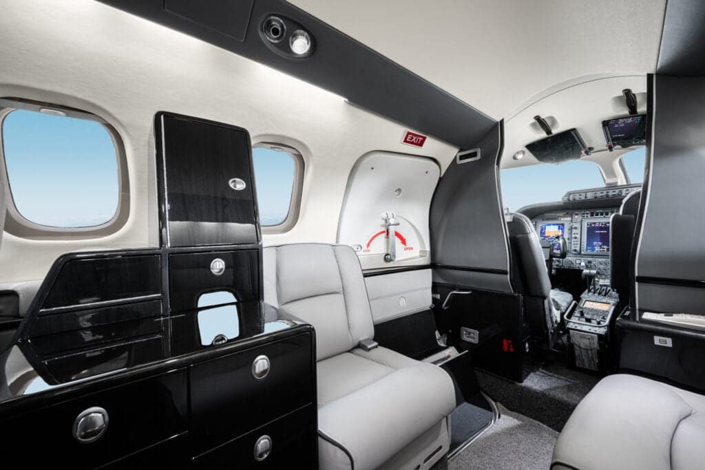 View of the interior of a Piaggio Avanti EVO aircraft, showing the seats and cabin features.
