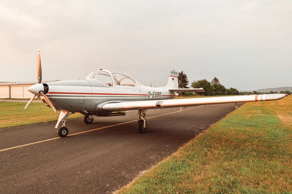 The D-EGWK aircraft is parked on the runway with a gray and white paint scheme.