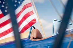 View from the cockpit of a biplane with an American flag.