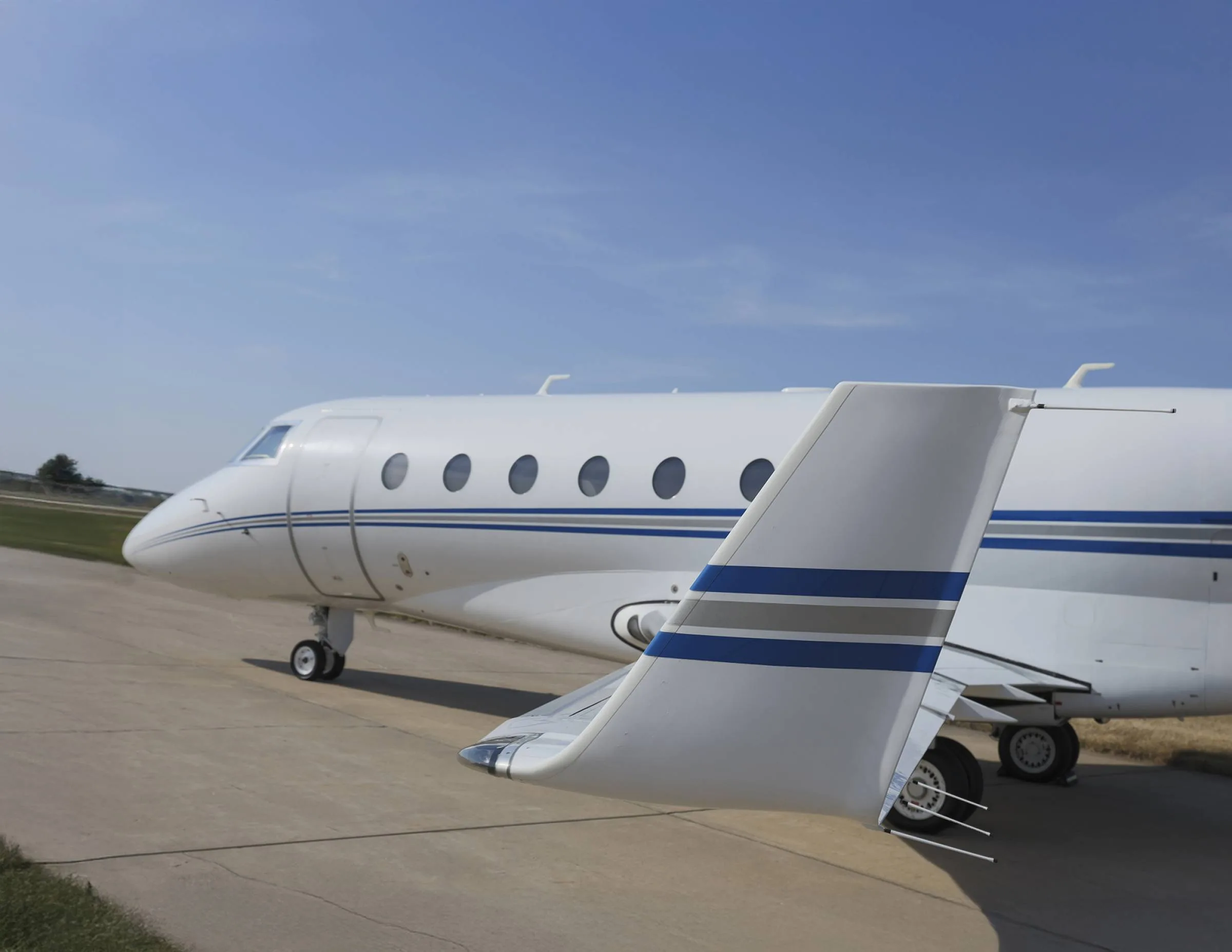 Close up of the tail of a white and blue Gulfstream jet.