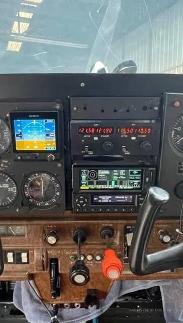 A close-up view of an aircraft cockpit instrument panel with a Garmin GNS 430 and other avionics.