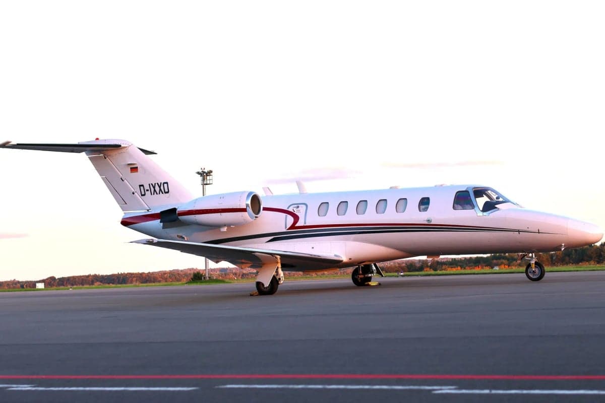 Side view of a Cessna Citation CJ1+ aircraft with registration D-IXXO.