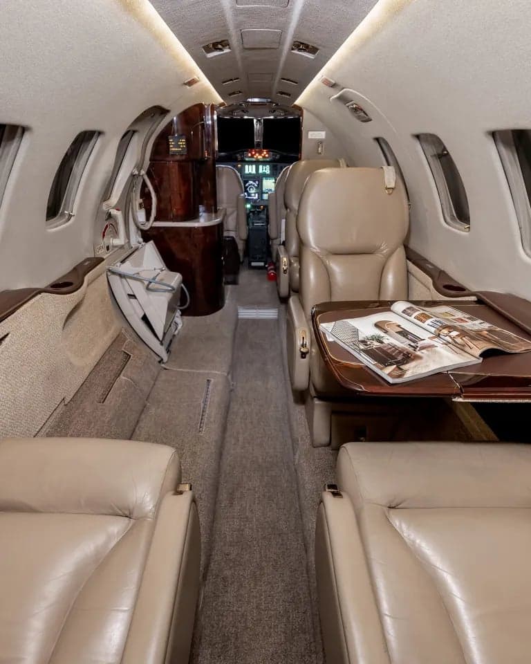 Full view of the aircraft interior showing the cockpit, seats, and refreshment center.