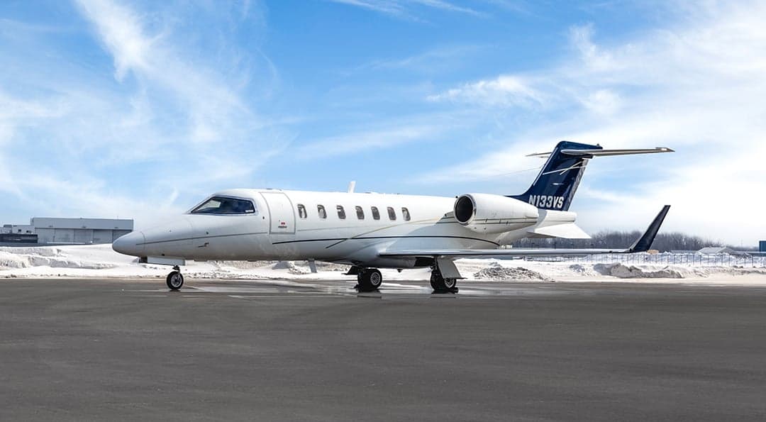 Learjet 45XR on the tarmac with snow on the ground.
