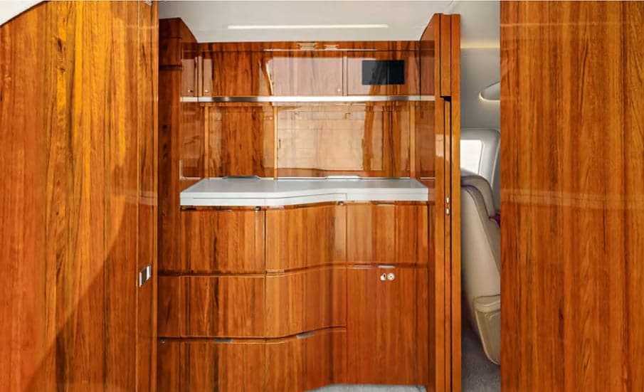 A view of the aircraft's galley area with wood cabinetry.