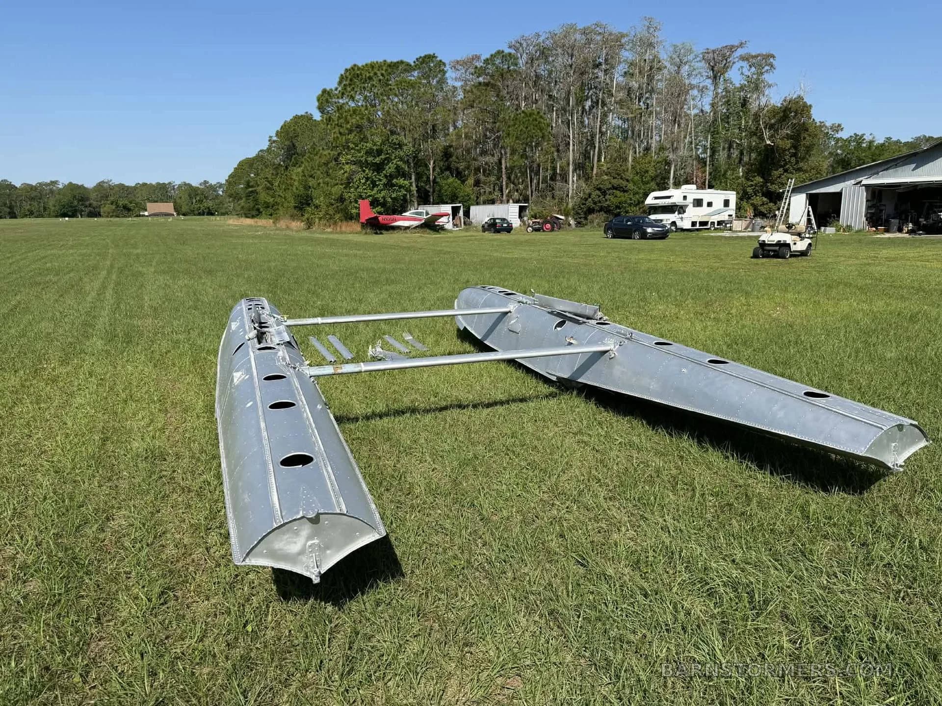 A pair of EDO float barrels positioned on grass.