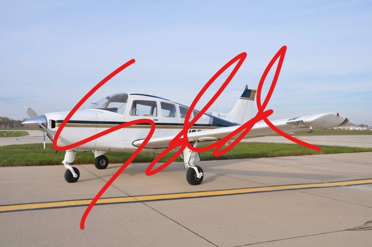 Side view of a white and gold aircraft on the tarmac with a SOLD overlay.