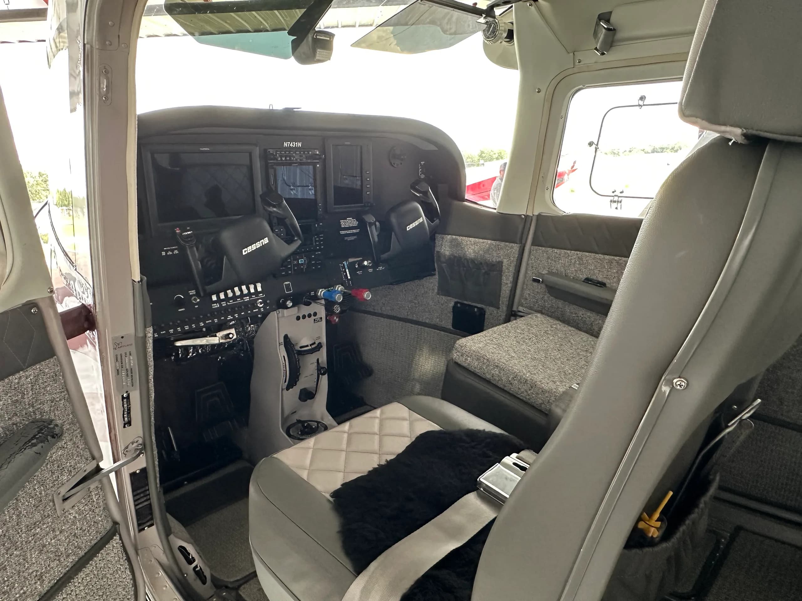 View of the Cessna 182 Skylane cockpit from the open door.