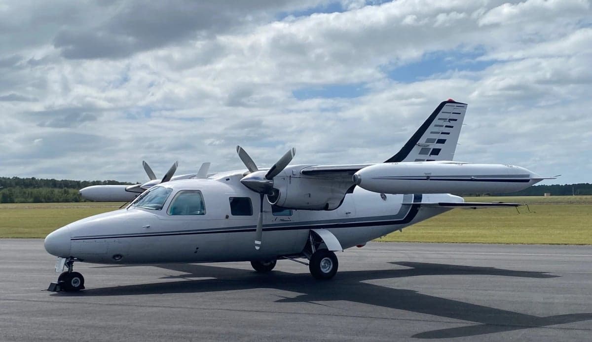 The aircraft N272MC is parked on the tarmac with a white and gray paint scheme.