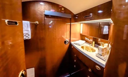 Interior of a private jet with a lavatory.