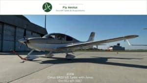 A Cirrus SR22 G3 Turbo aircraft with a white and gray paint scheme parked on the tarmac.