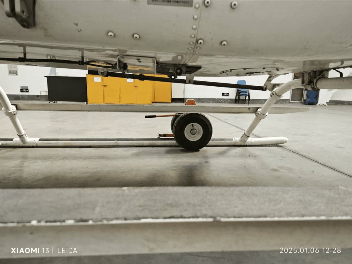 Close up of the underside of the helicopter on a wheeled dolly.