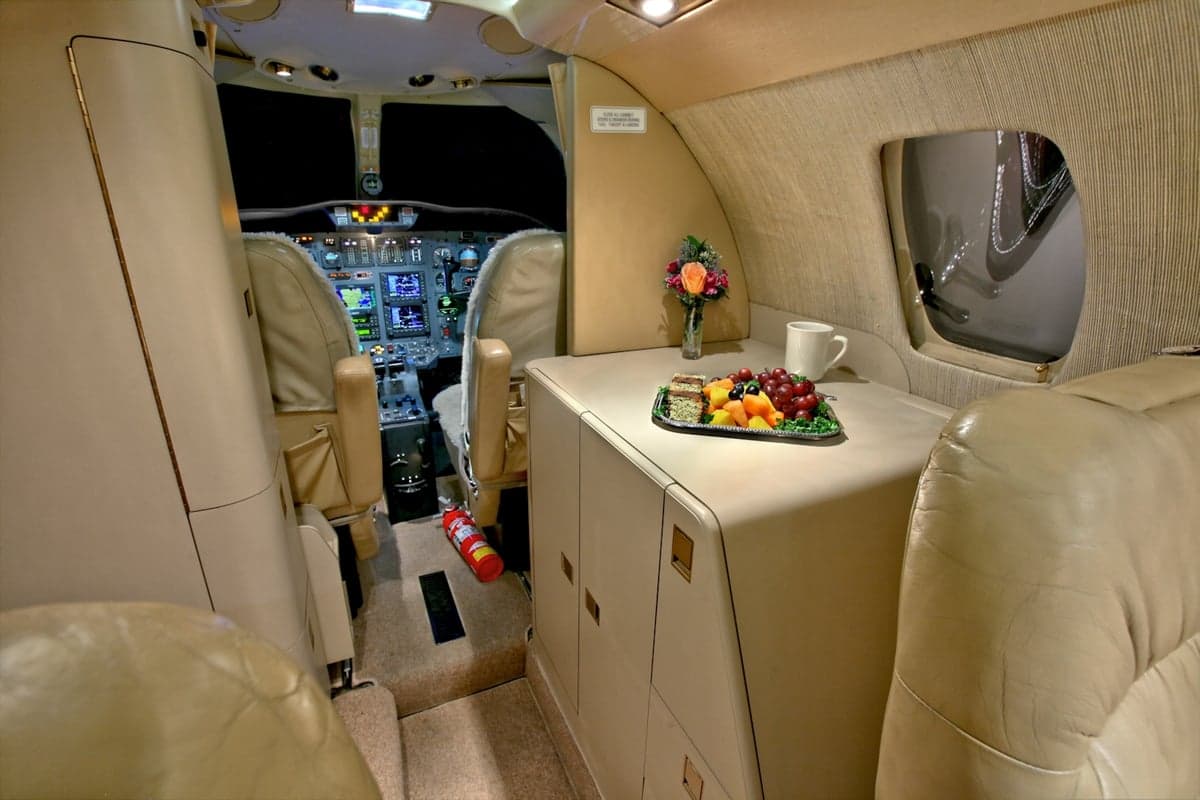 The CitationJet's interior includes a refreshment center and view of the cockpit.