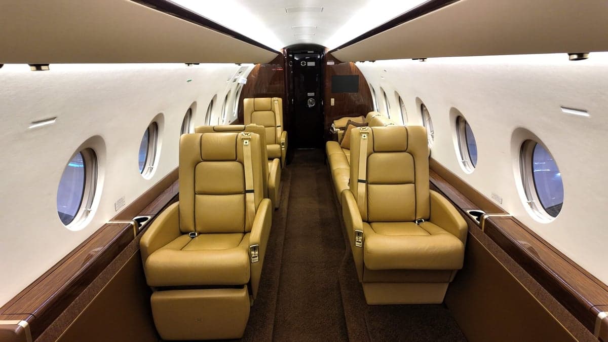 Interior view of the aircraft galley with sink and cabinets.
