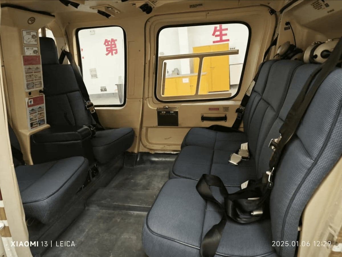 Interior view of the helicopter cabin with blue seats.