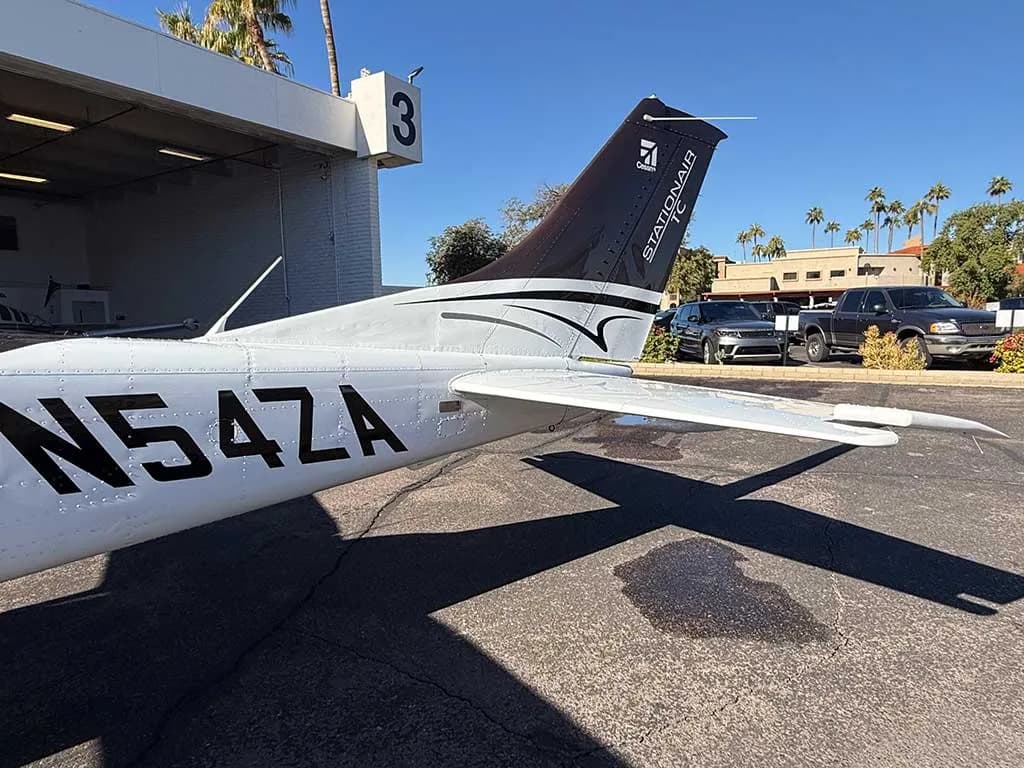 A close-up view of the tail section of the brown and white Cessna 182 Skylane N54ZA, showing the registration.