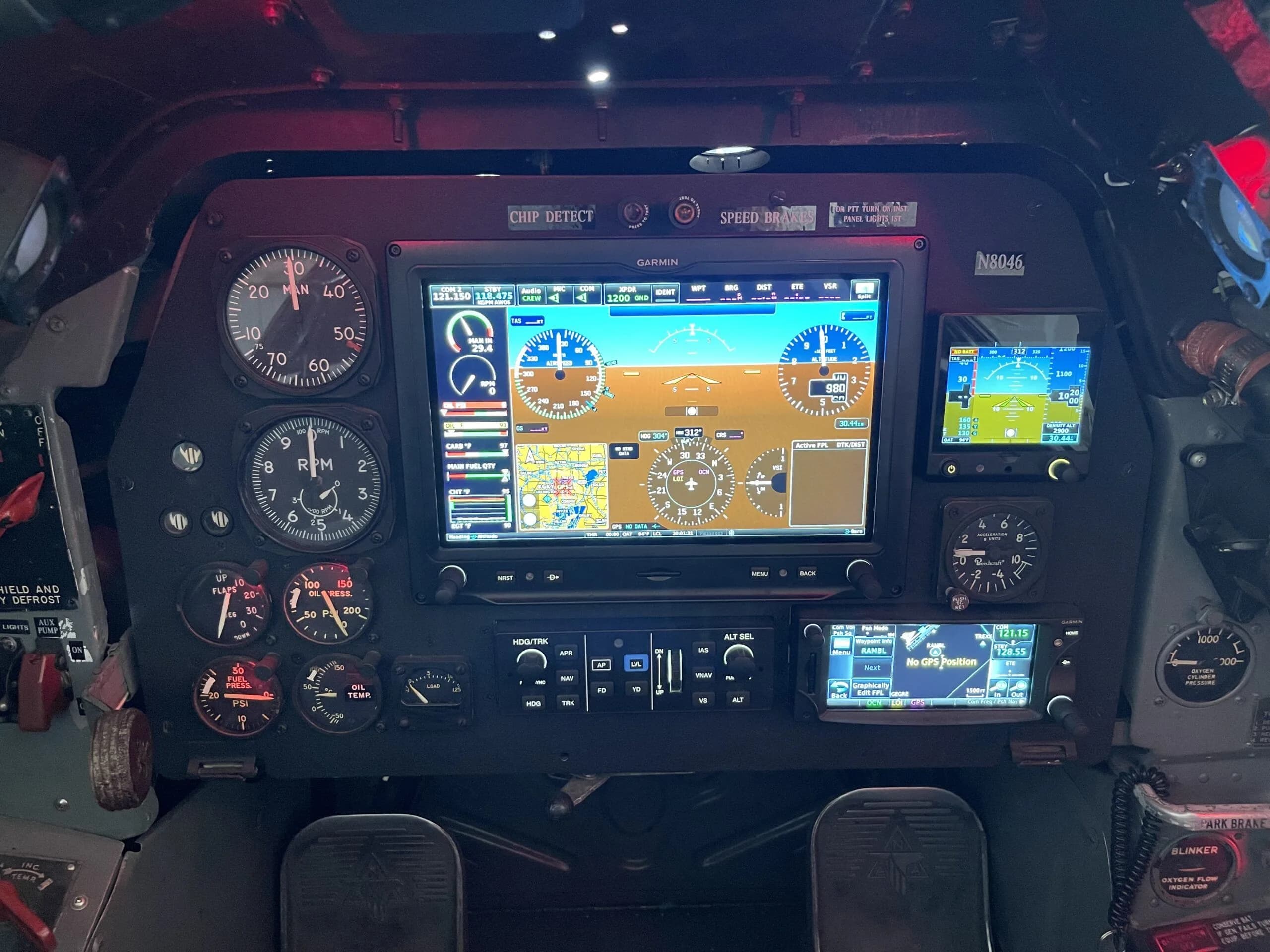 A detailed view of the T-28 Trojan's instrument panel, showing the primary flight display, navigation screen, and engine instruments.