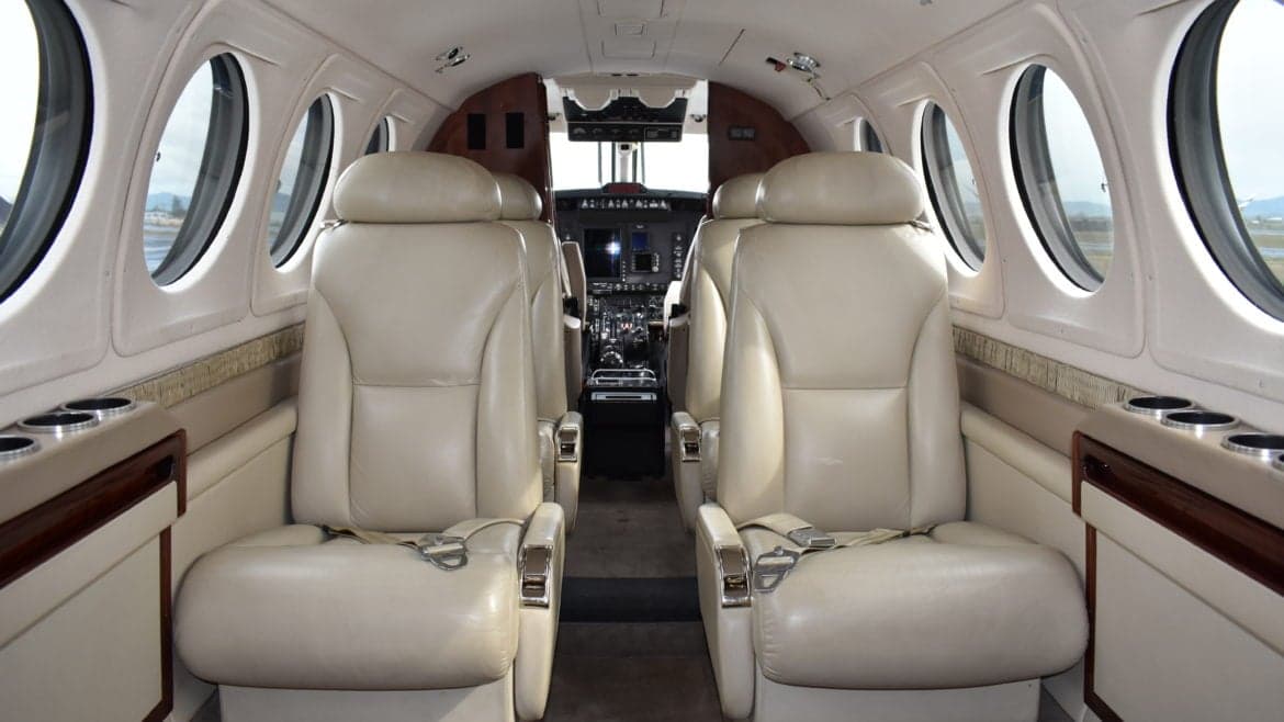 The interior of the King Air features tan leather seats and oval windows.