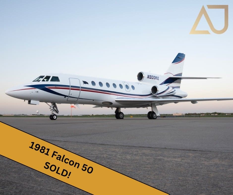 A 1981 Falcon 50 aircraft with registration N900KE is parked on the tarmac with a 'SOLD' banner overlay.