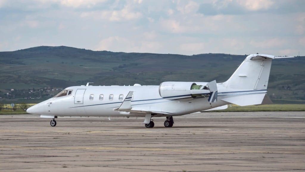 A Learjet aircraft parked on the tarmac.